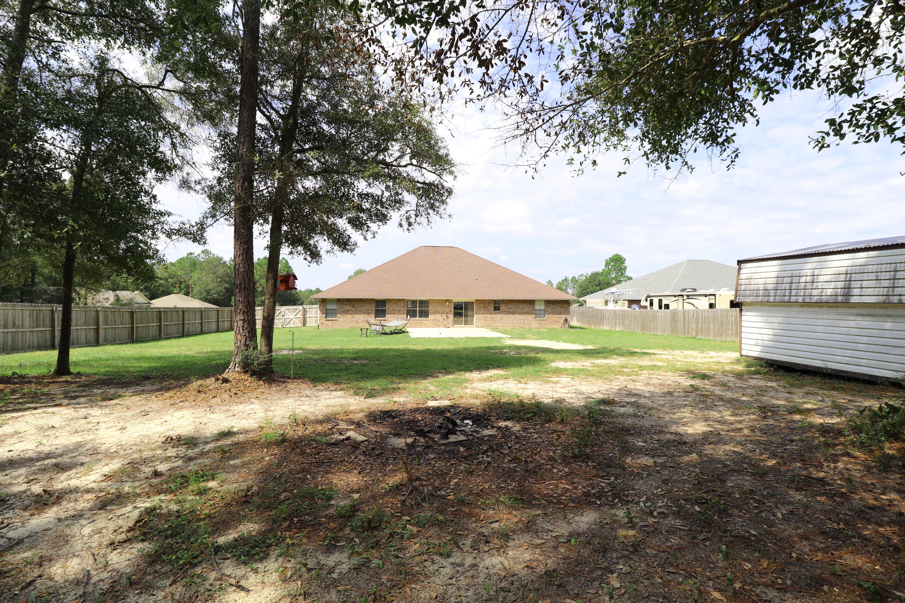 6181 Hummingbird Lane Crestview, FL 32536 - Photo 41 of 56 a view of a house with yard and sitting area