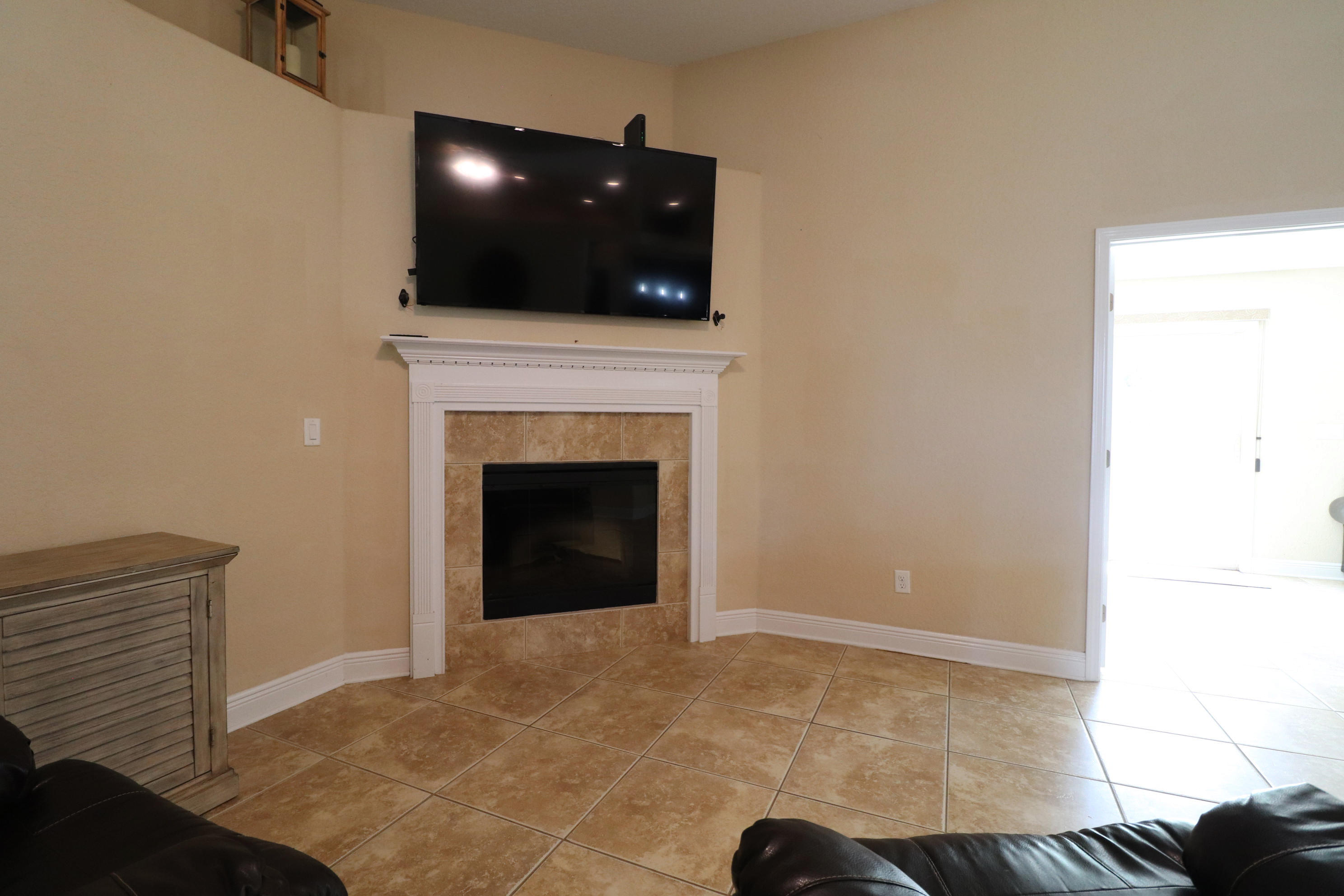 6181 Hummingbird Lane Crestview, FL 32536 - Photo 8 of 56 a view of an empty room with a fireplace and wooden floor