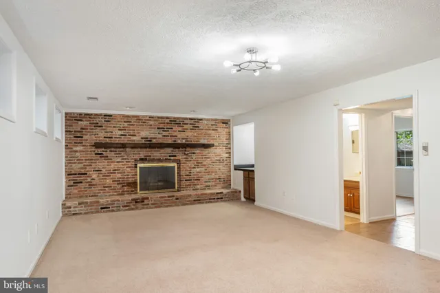 a view of an empty room with a fireplace