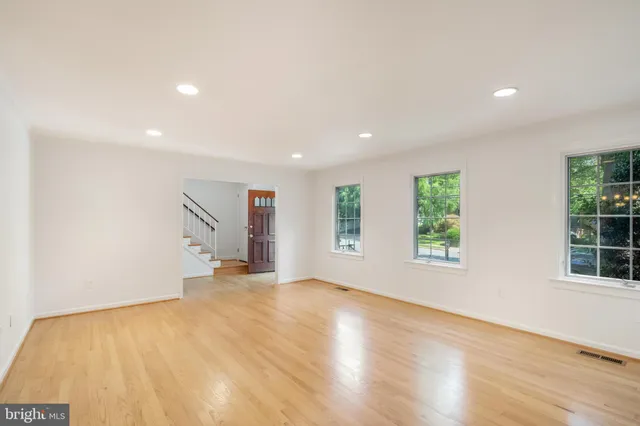 a view of an empty room with a window and fire place