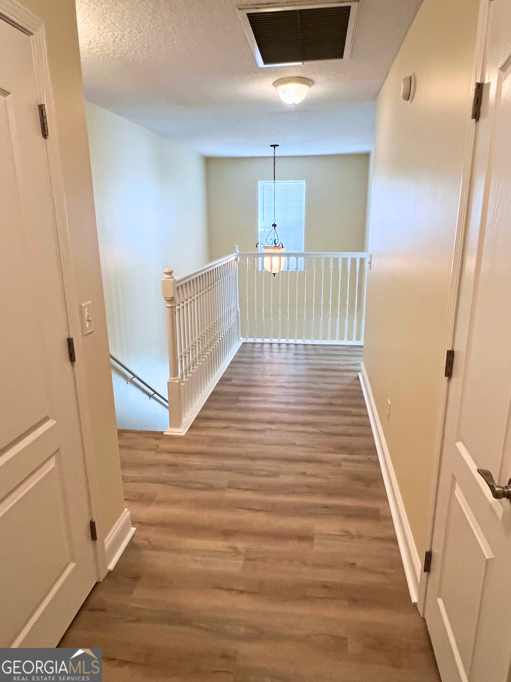 822 Davis Avenue Kingsland, GA 31548 - Photo 13 of 24 a view of a hallway view with wooden floor and staircase