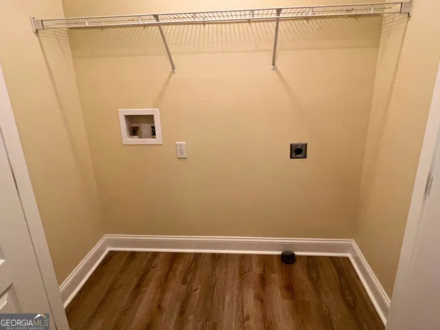 a view of a room with wooden floor and small window