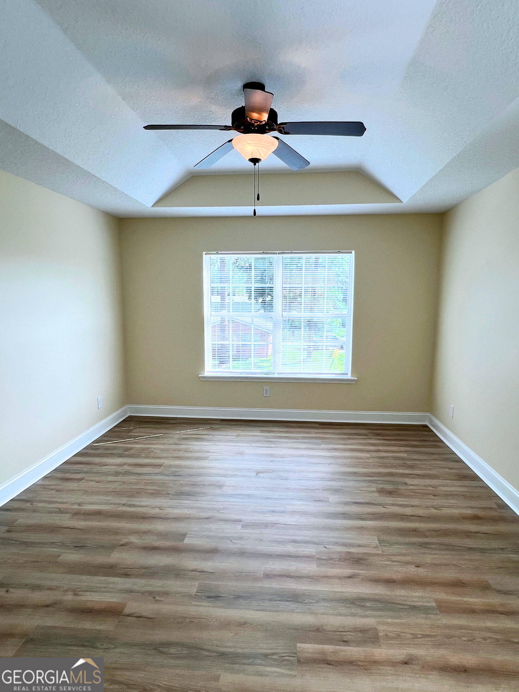 822 Davis Avenue Kingsland, GA 31548 - Photo 15 of 24 a view of an empty room with wooden floor and a window