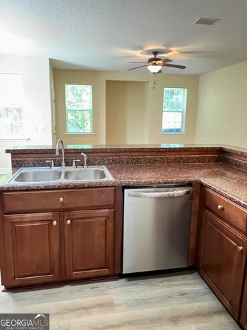 a kitchen with a sink and a mirror