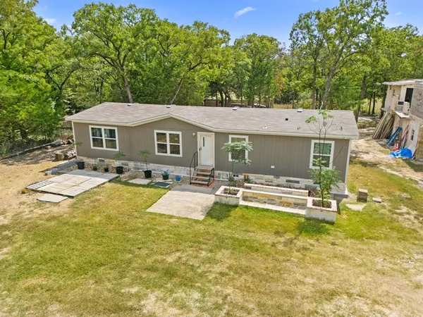 a view of a house with swimming pool and sitting area