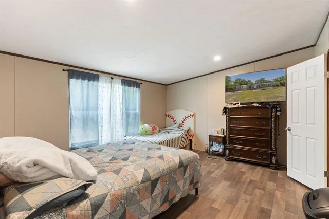 a bedroom with a bed and a flat tv screen