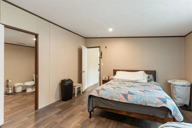 a bedroom with a bed and a view of bathroom