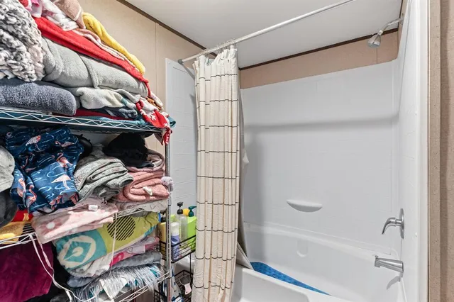 a view of walk in closet with clothes