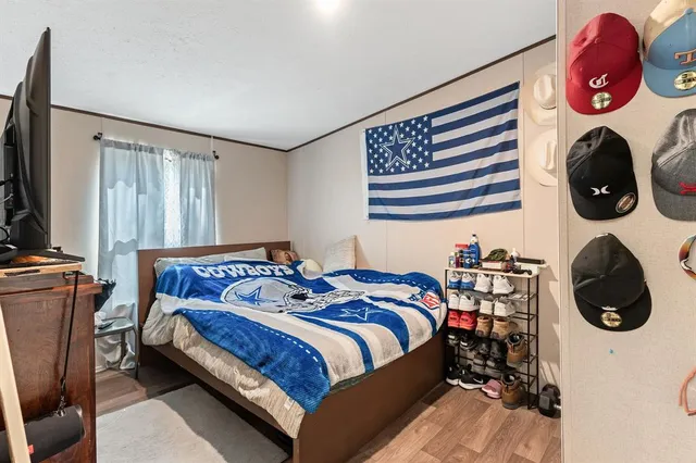 a bedroom with bed and a window