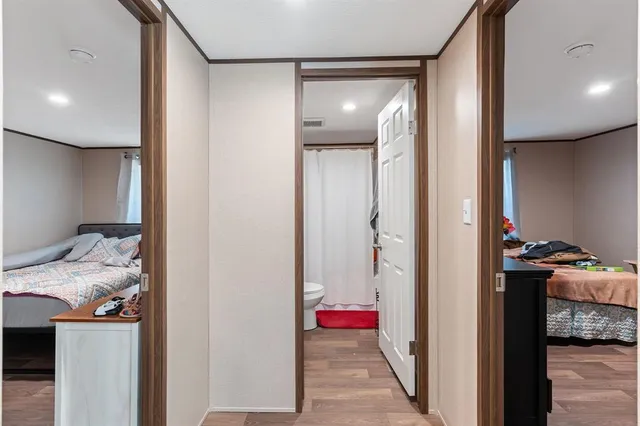 a view of a hallway and a livingroom with furniture