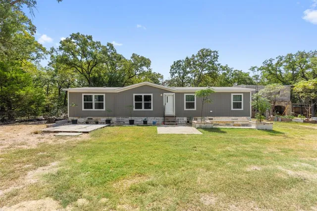 a view of a house with swimming pool and a yard