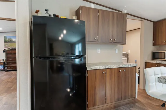 a kitchen with a refrigerator and cabinets