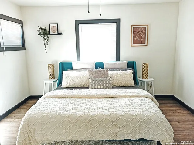 a bedroom with a bed and wooden floor