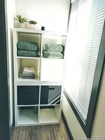 a bed sitting in a bedroom next to a window