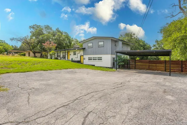 a view of a house with a yard and a garage