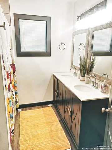 a bathroom with a sink vanity and a mirror