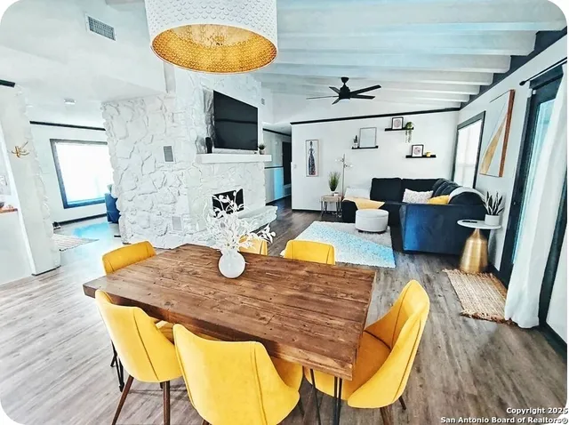 a dining room with furniture and wooden floor