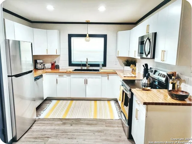 a kitchen with sink refrigerator and stove