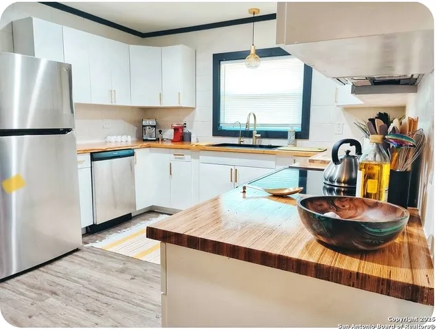 a living room with furniture kitchen view and a large window