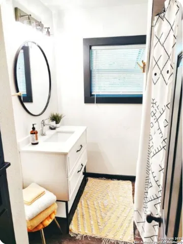 a bathroom with a sink and a mirror