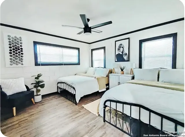 a bedroom with two beds and a window