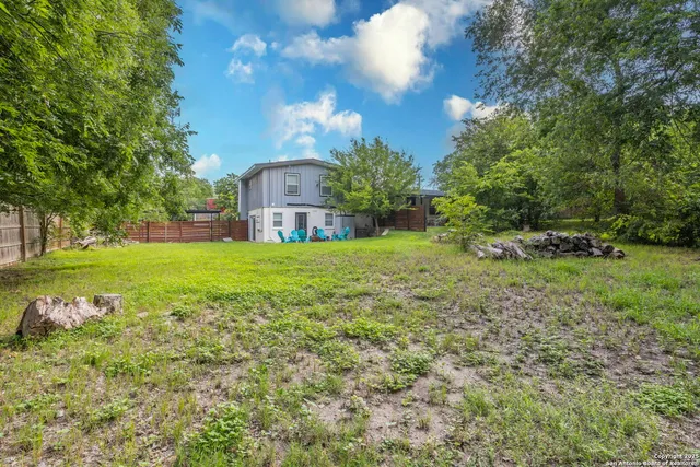 a view of green field with trees in the background