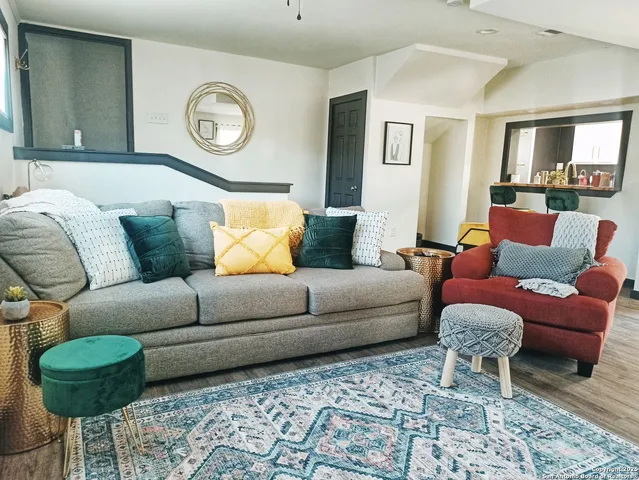 a living room with furniture and a rug