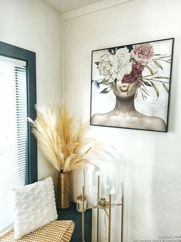 a view of a bedroom with a bed and potted plant