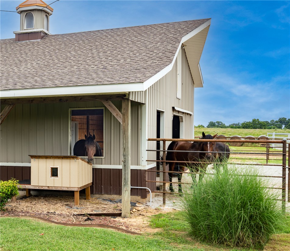 16556 East Hewitt Springs Road Springdale, AR 72764 - Photo 12 of 60 Barn structure featuring a cupola with a copper dome, corrugated metal siding, and an asphalt shingle roof