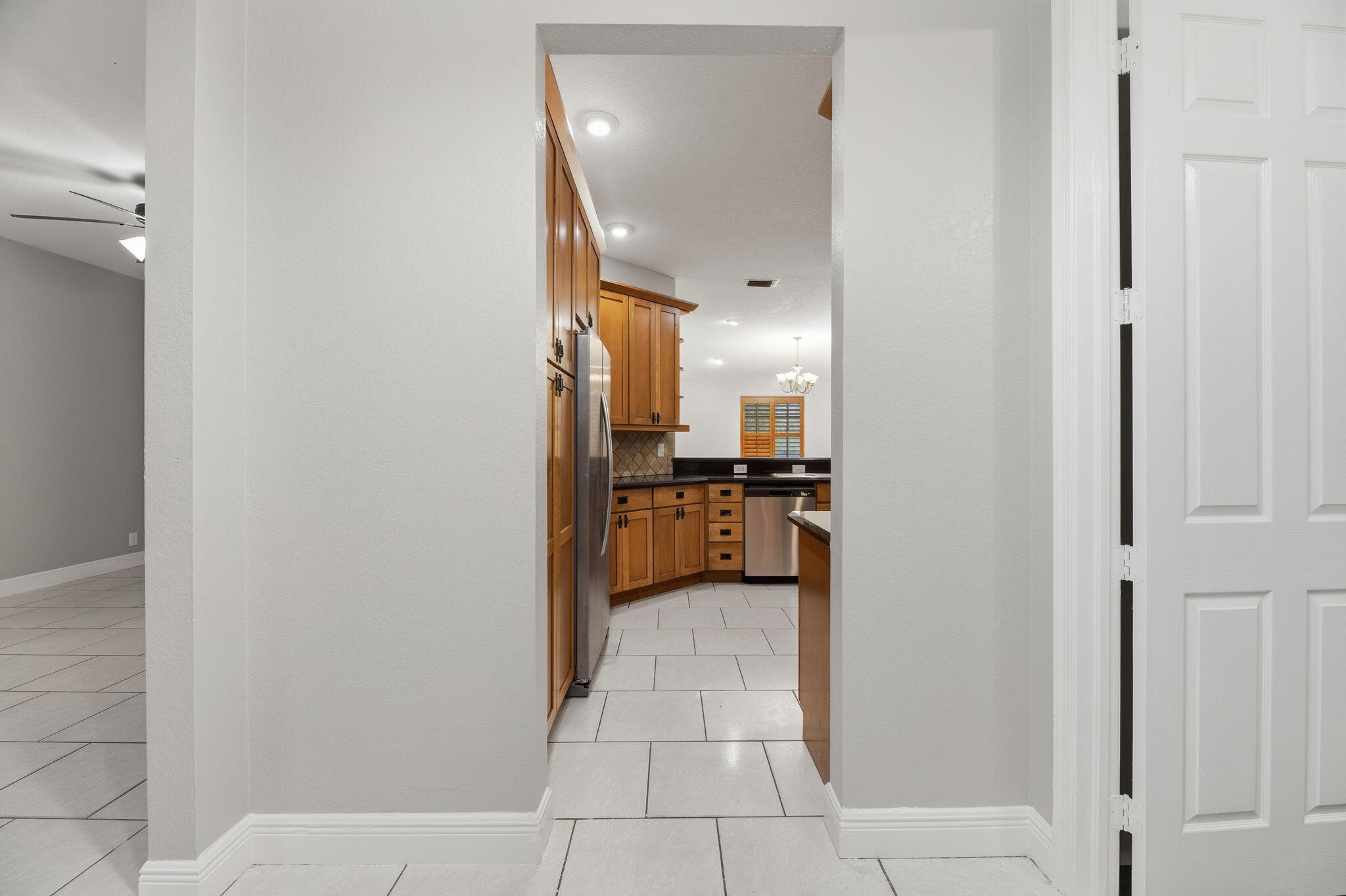 15731 85th Road North Loxahatchee, FL 33470 - Photo 17 of 65 a view of a kitchen with a refrigerator and a stove