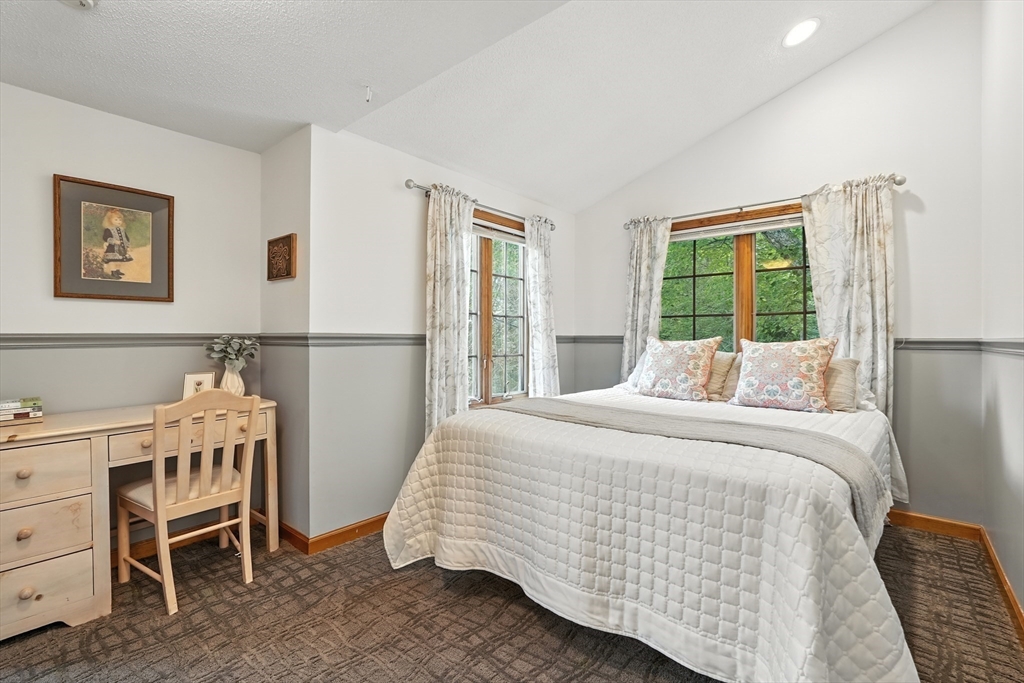 254 Ames Road Hampden, MA 01036 - Photo 35 of 42 a bedroom with a bed and a table in it