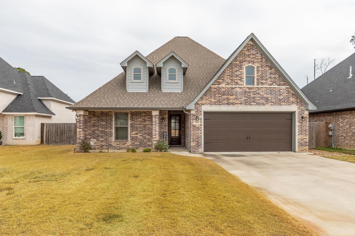 314 Long Leaf Street Silsbee, TX 77656 - Photo 1 of 31 a front view of a house with a yard and garage