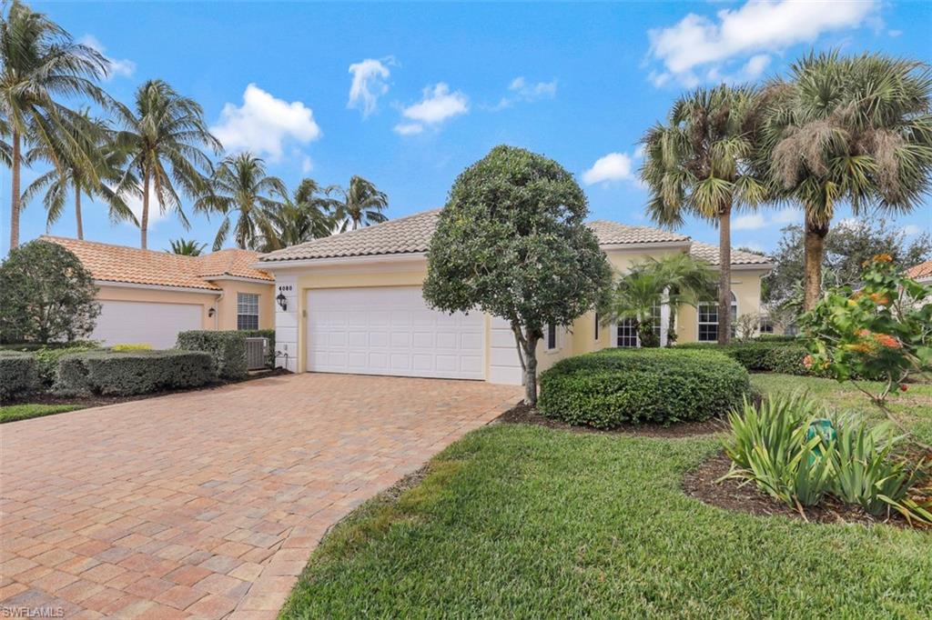 4080 Trinidad Way Naples, FL 34119 - Photo 1 of 35 a front view of a house with a garden
