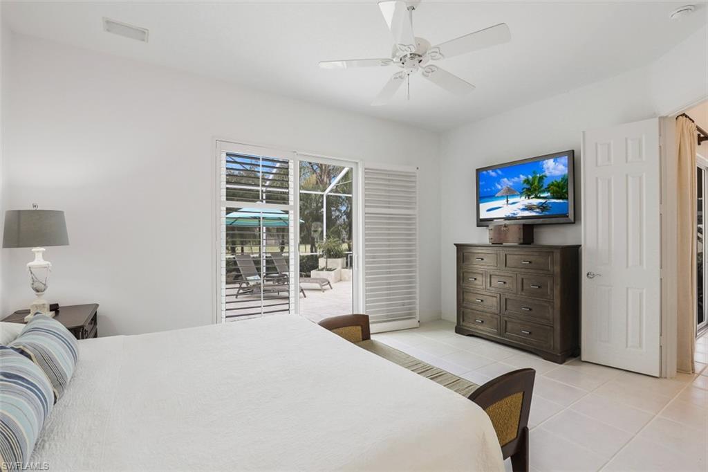 4080 Trinidad Way Naples, FL 34119 - Photo 12 of 35 a bedroom with a bed and a flat screen tv
