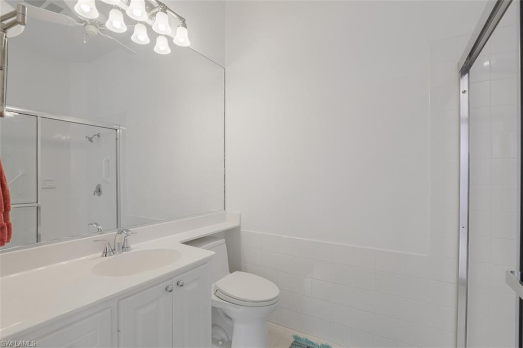 4080 Trinidad Way Naples, FL 34119 - Photo 15 of 35 a bathroom with a sink a toilet and shower