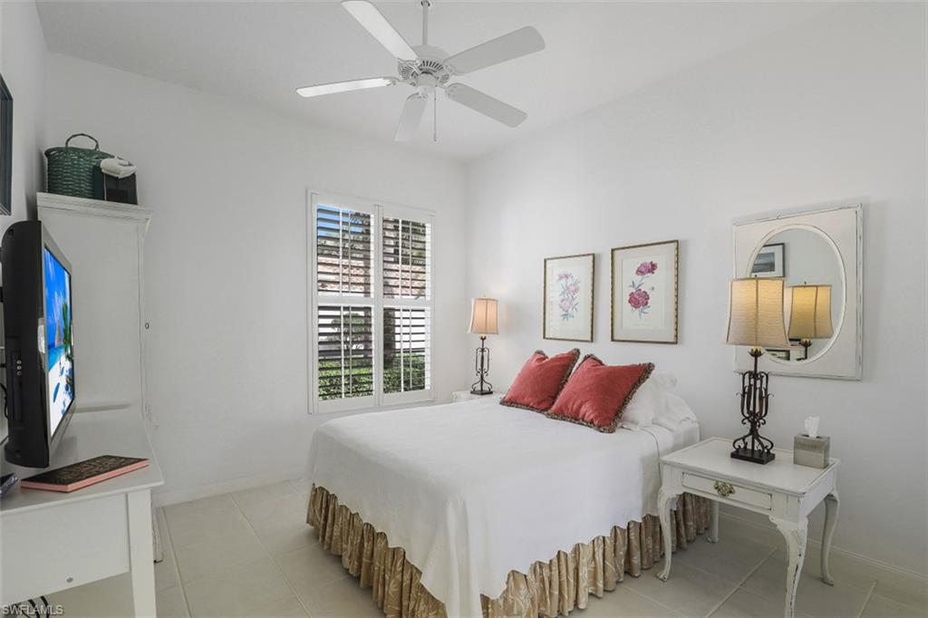 4080 Trinidad Way Naples, FL 34119 - Photo 18 of 35 a bedroom with a bed and a flat screen tv