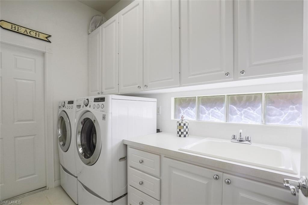4080 Trinidad Way Naples, FL 34119 - Photo 19 of 35 a utility room with sink dryer and washer
