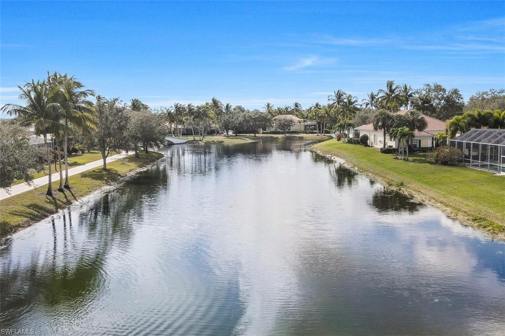 4080 Trinidad Way Naples, FL 34119 - Photo 33 of 35 a view of a lake with houses in the back