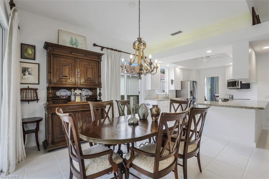 4080 Trinidad Way Naples, FL 34119 - Photo 7 of 35 a view of a dining room with furniture