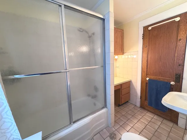 a bathroom with a shower and a toilet