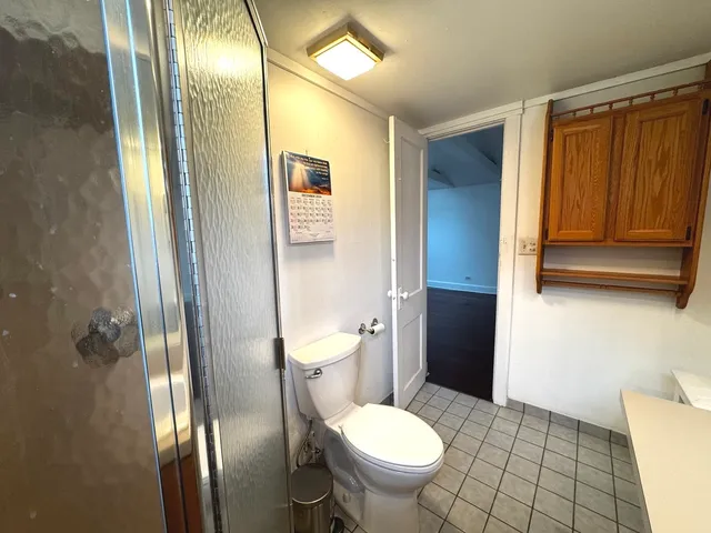 a bathroom with a toilet and a mirror