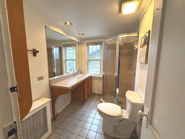a bathroom with a sink toilet and shower