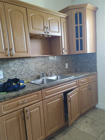a kitchen with stainless steel appliances granite countertop a sink dishwasher stove and cabinets