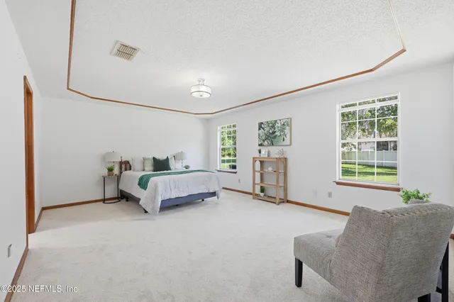 a spacious bedroom with a bed and a couch