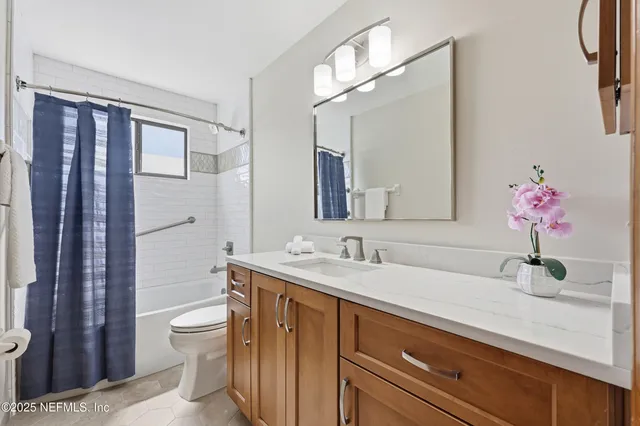 a spacious bedroom with a bed a window and closet