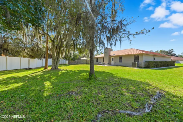 a backyard of a house with lots of green space