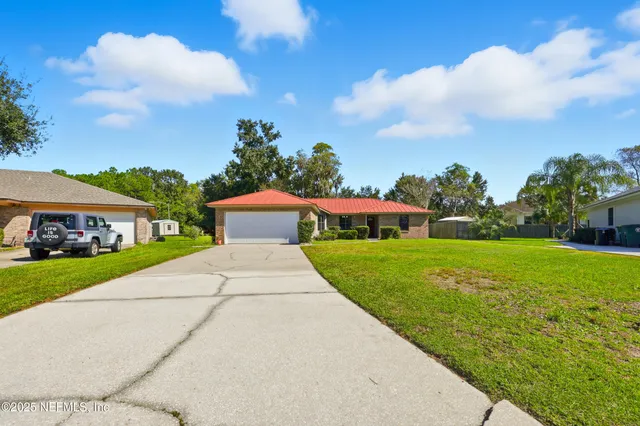 a view of a house with pool and a yard