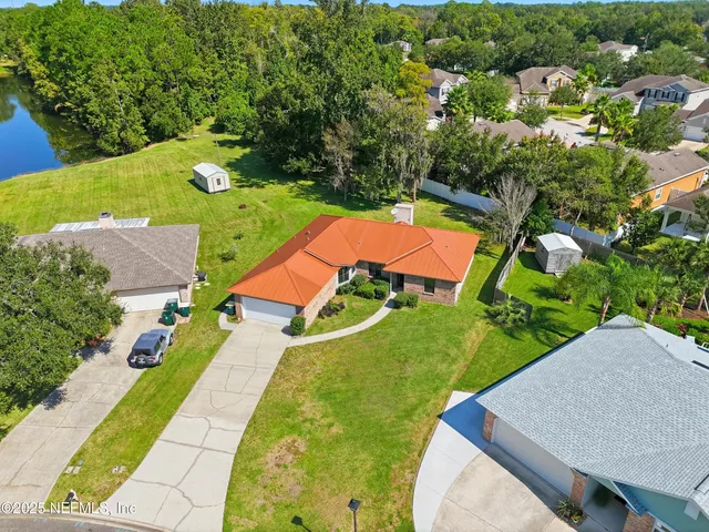 an aerial view of residential houses with outdoor space and street view