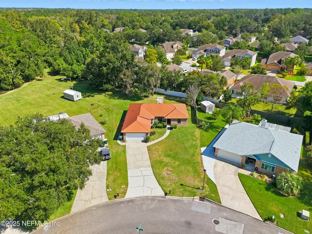 an aerial view of a house with a yard