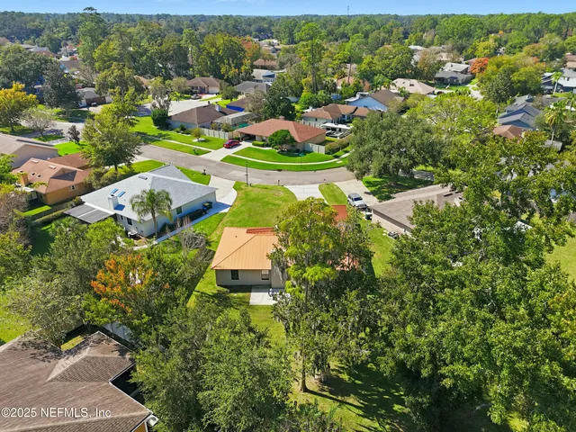 an aerial view of a house with a yard